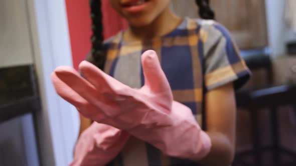 Girl wearing gloves in kitchen 4k