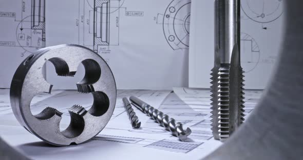 Designer desk of mechanical parts. Mechanical diagrams, bearings and drill.