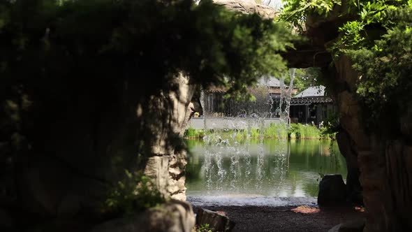 small waterfall near lake with stones in summer