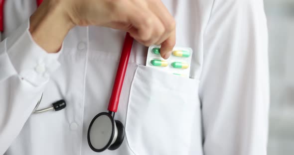 Doctor Takes Out Blister with Pills From Pocket