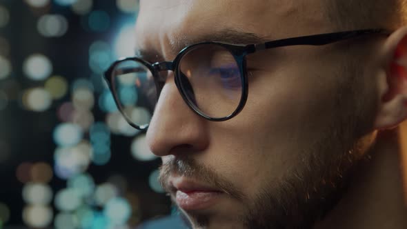 Close-up portrait of a young man working at the computer.