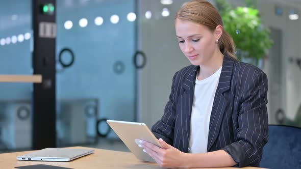 Serious Professional Young Businesswoman Using Tablet