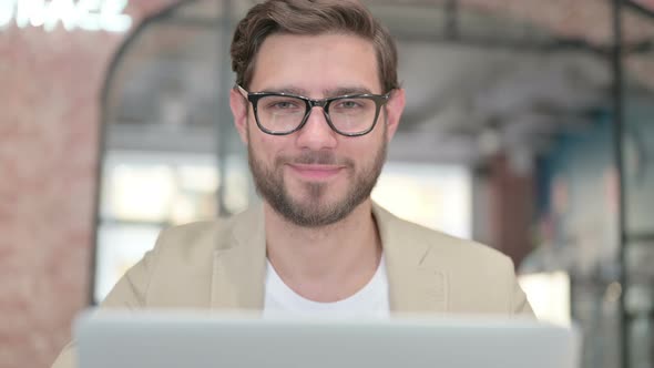 Man with Laptop Shaking Head As No Sign