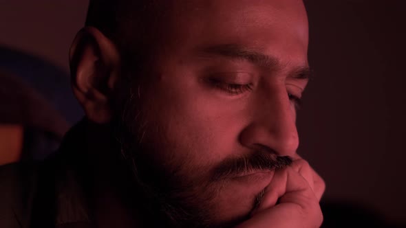 Ethnic Minority Bald Male With Mood Lighting, Hand On Chin Thinking. Locked Off