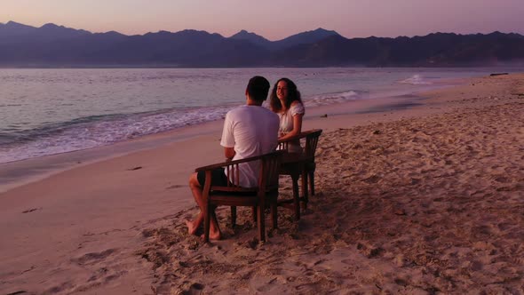 Guy and girl in love on relaxing tourist beach voyage by aqua blue ocean and white sand background o