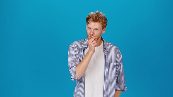 Young Man Calls to Keep Mouth Shut on Blue Background