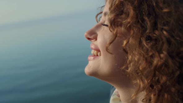 Closeup Face Happy Girl in Front Blue Ocean