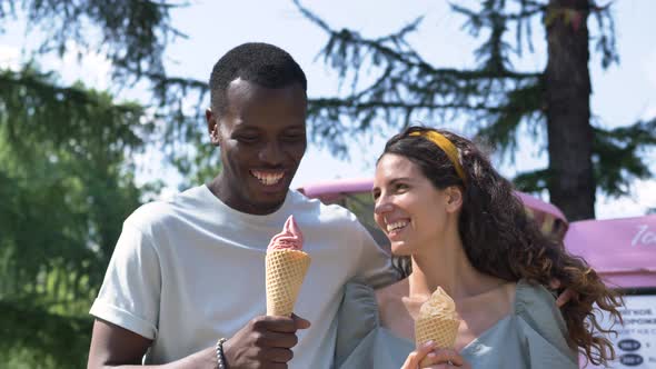 Different Races Couple Eats Icecream Cones Laughing