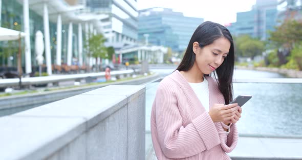 Woman Using Mobile Phone at Outdoor