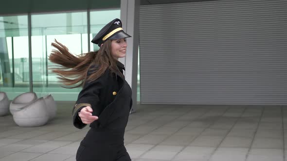 Happy Dancing Female Pilot Wearing Uniform