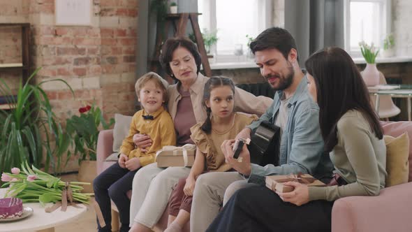 Man Playing Guitar With Family