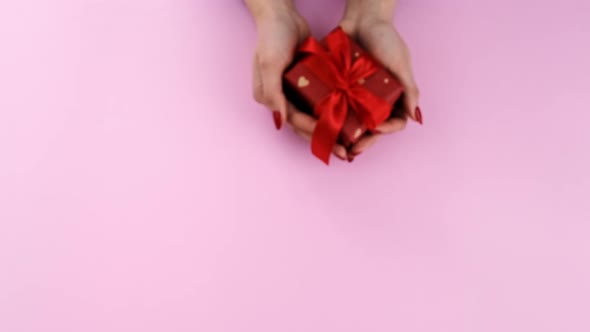 A Gift in the Hands of a Woman on Valentine's Day