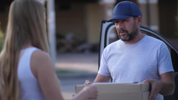 Pizza Delivery Man Giving Boxes To Female Client