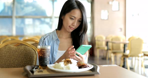 Woman Use of Smartphone in Restaurant 