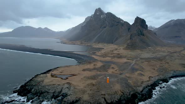 Dramatic Iceland Eastern Fjord Coastline with Orange lighthouse