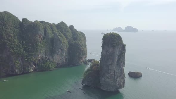 Aerial footage of Ao Nang beach, limestone rocks in sea, sailing boats. Krabi province, Thailand.