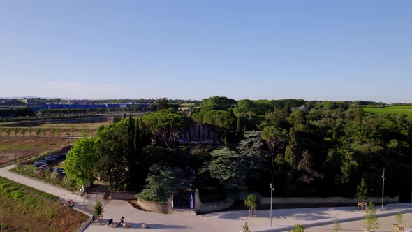 The beautiful villa being shown behind some big trees in Montpellier, France.