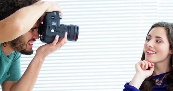 Photographer showing photos to fashion model