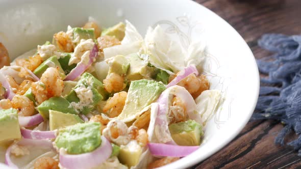 Young Women Eating Avocado Salad