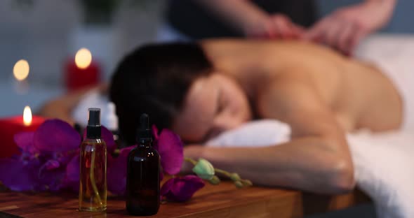 Cosmetic Aroma Oils Standing Near Client and Massage Therapist in Spa Closeup  Movie