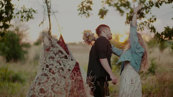 Young Attractive Couple Embracing and Smiling While on Camp