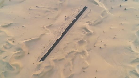 Aerial abstract view of road covered by sand in the desert, Abu Dhabi, U.A.E.