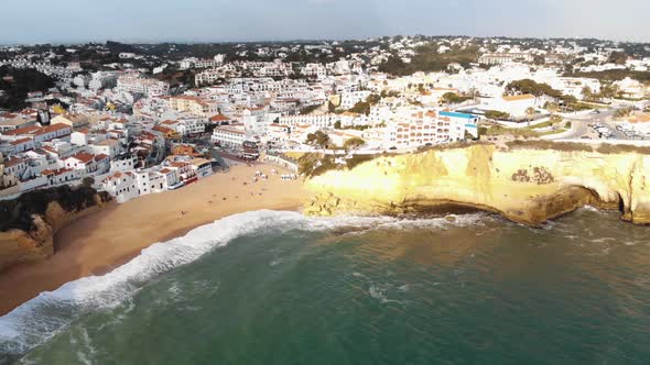 Panoramic view of Carvoeiro Beach and townscape at sunset - Wide Aerial shot