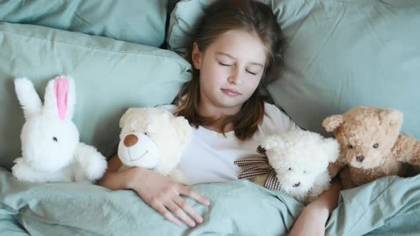 Girl with Teddy Bear Toys in Bed