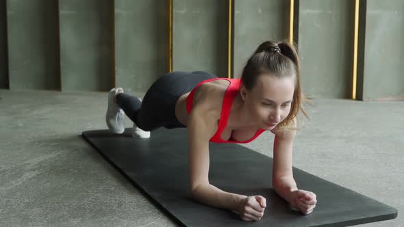 Young Sporty Woman Doing Leg and Buttocks Exercises