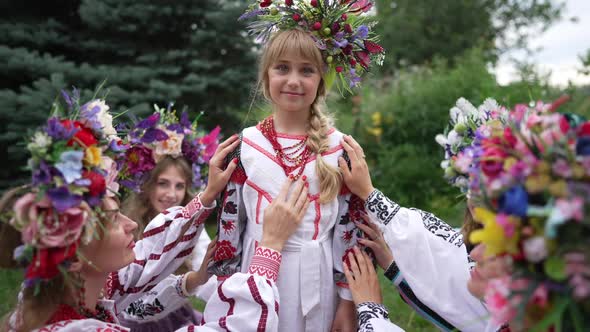 Portrait of Confident Charming Ukrainian Girl Looking at Camera Smiling Standing in Park with Group