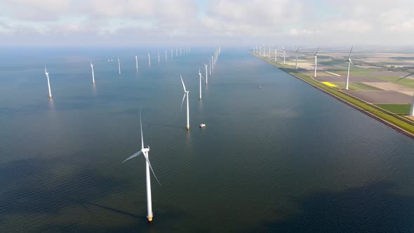 Offshore Windmill Park with Clouds and a Blue Sky Windmill Park in the Ocean Drone Aerial View with