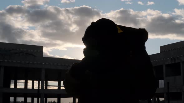 Unrecognizable Woman Puts Off Take Off Yellow Hood and Gas Mask and Breath Sun Shines Into Camera