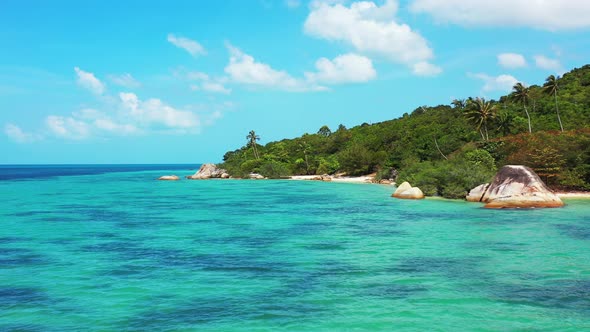 Wide angle above copy space shot of a white sandy paradise beach and turquoise sea background in col