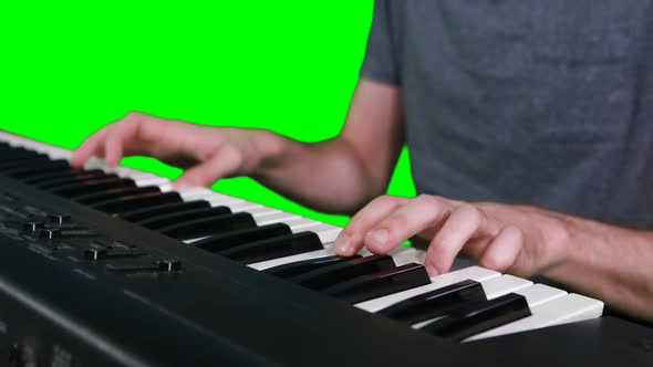 Mid section of musician playing electronic piano
