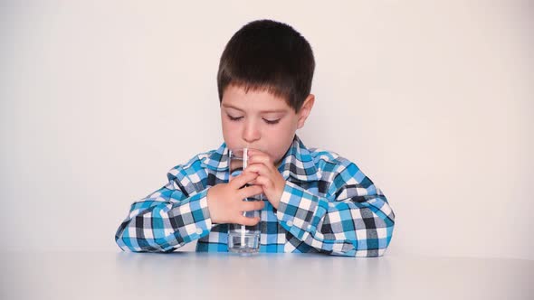 A 4Yearold Boy Laughably Drinks Water From a Glass