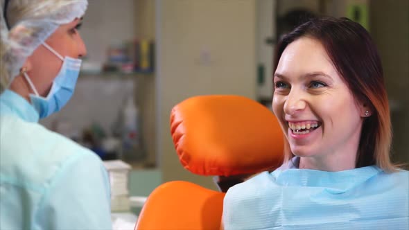 Patient of the Dental Clinic Asks the Doctor About Caring for Her Teeth