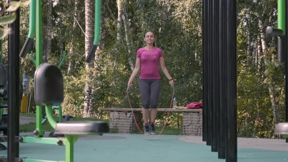 Sporty Female Skipping on Rope in an Outdoor Gym