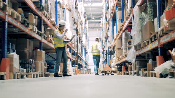 Warehouse Worker Passes Information on Walkie-talkie