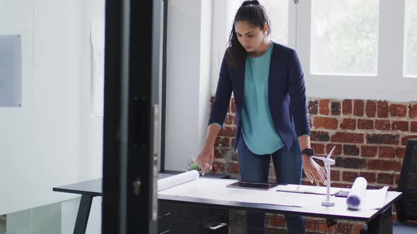 Woman checking plan document  at office