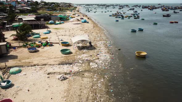 Aerial, traditional round coracle fishing boats floating on coast in Vietnam