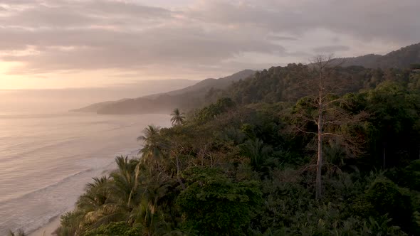 Punta Uvita and Beach in western Costa Rica Central America during dusk, Aerial flyover shot