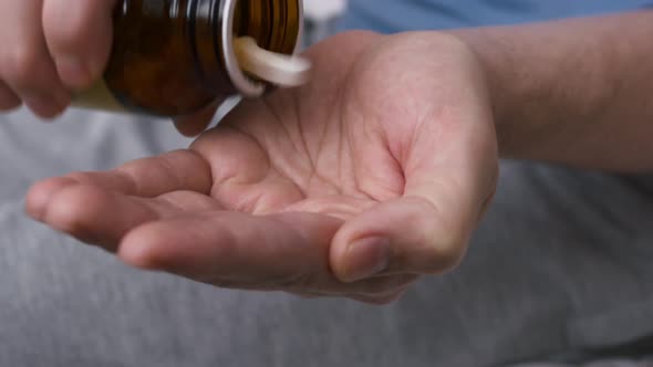 Closeup on the Hand Poured Pills for the Treatment of the Disease