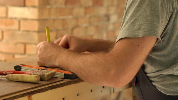 Worker measuring and making marks 