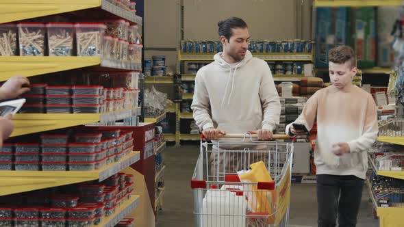 Man and Boy Shopping for Home Improvement Supplies