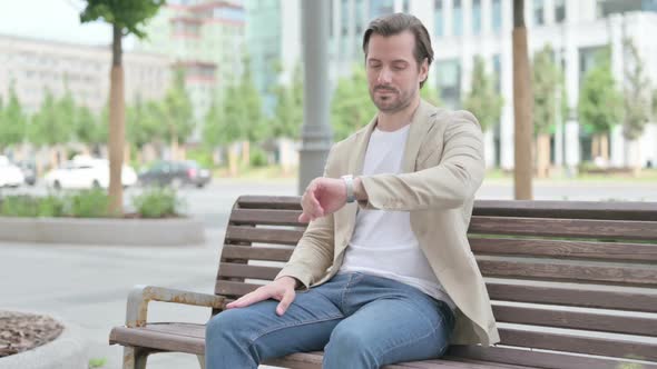 Waiting Young Man Leaving Bench After Checking Time