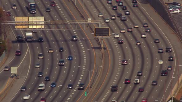 A static, medium shot of flowing cars on the freeway in Atlanta, Georgia.