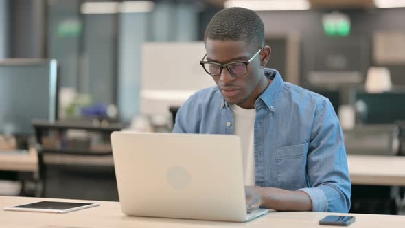 Young African American Man Reacting to Loss at Work