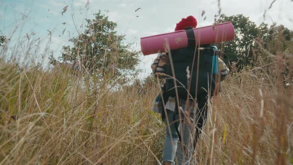 Woman with tourist backpack hiking alone