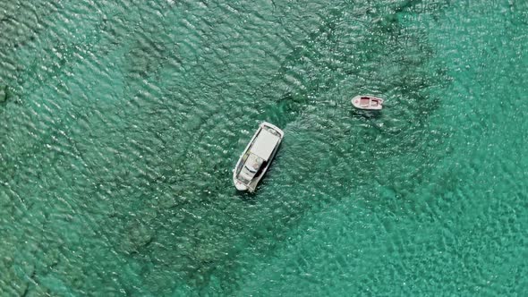 Regular boat sailing on crystal clear water of Mediterranean sea, aerial top down view