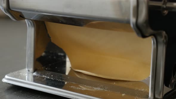 Pasta machine processed dough 4K 2160p 30fps UltraHD footage - Close-up of manually shaped lasagna s